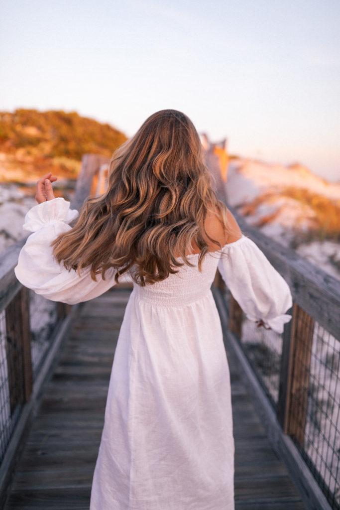 woman-wearing-white-dress-with-beachy-curled-hair