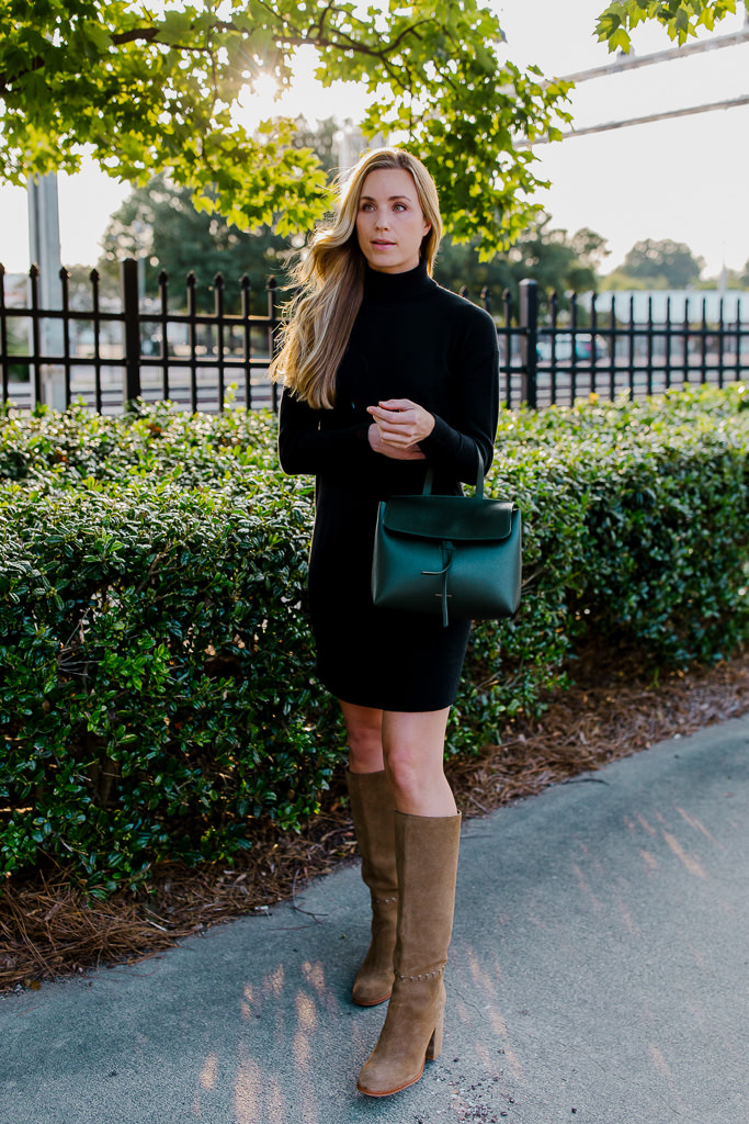 woman wearing black turtleneck sweater dress with knee high suede boots