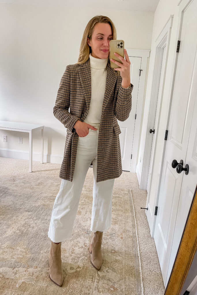 plaid blazer winter outfit with white sweater, white jeans, and tan booties