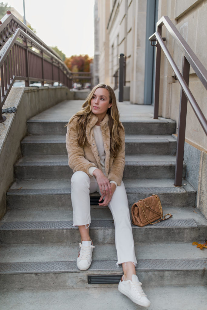 Natalie Yerger wearing golden goose sneaker outfit white jeans faux fur coat Tory Burch bag white sweater