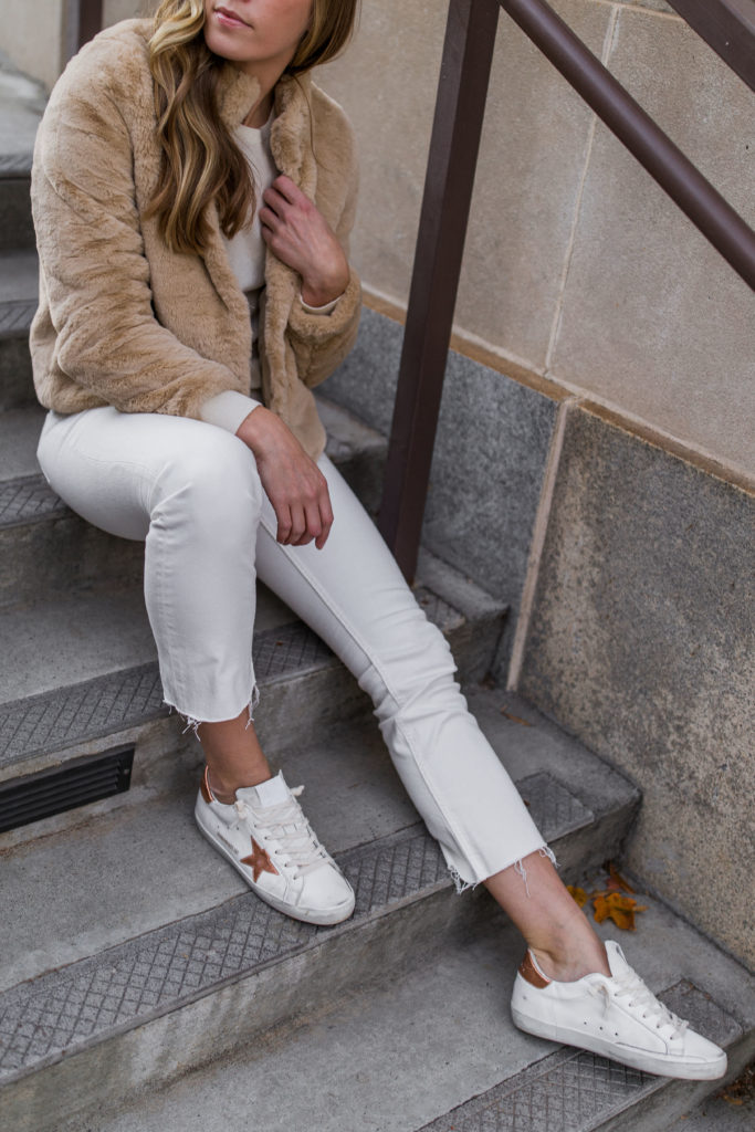 Golden goose superstar sneaker winter outfit with white jeans and faux fur jacket