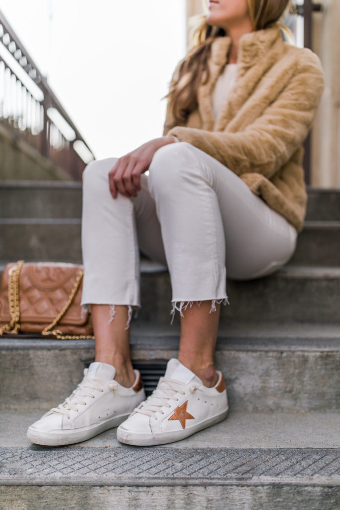 Natalie Yerger wearing faux fur jacket white sweater white jeans golden goose superstar casual outfit
