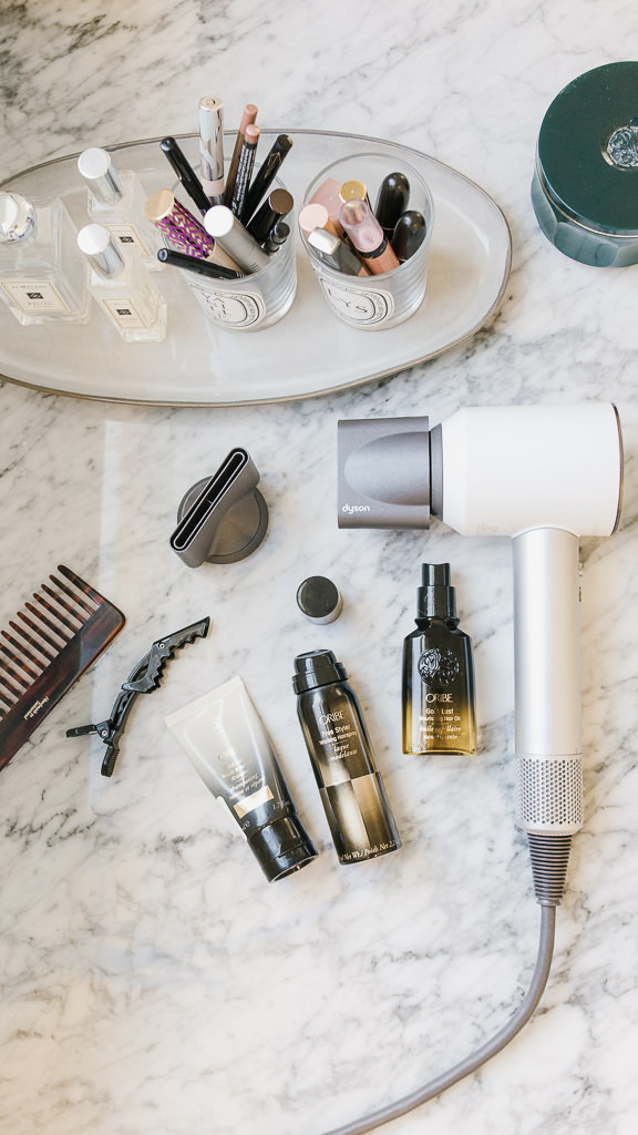 Oribe miniature products on countertop Oribe gold lust oil Oribe Gold Lust conditioner Oribe signature shampoo