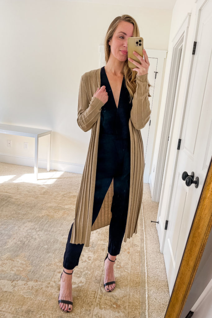 Natalie Yerger wearing long cardigan outfit with black jumpsuit and Schutz strappy heels