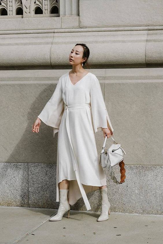 woman wearing white maxi dress with white heeled booties outfit