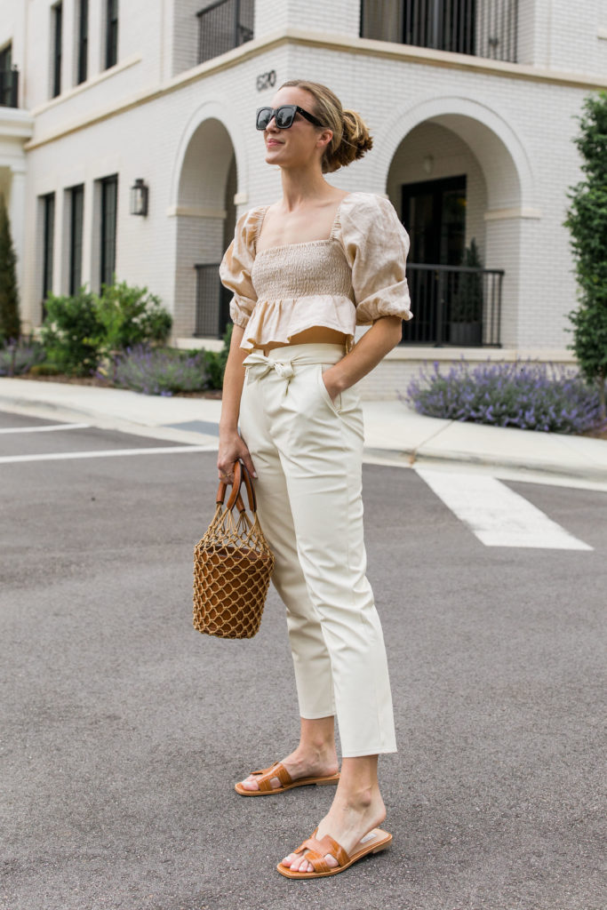summer white faux leather pants outfit with sandals puff sleeve crop top and bucket bag