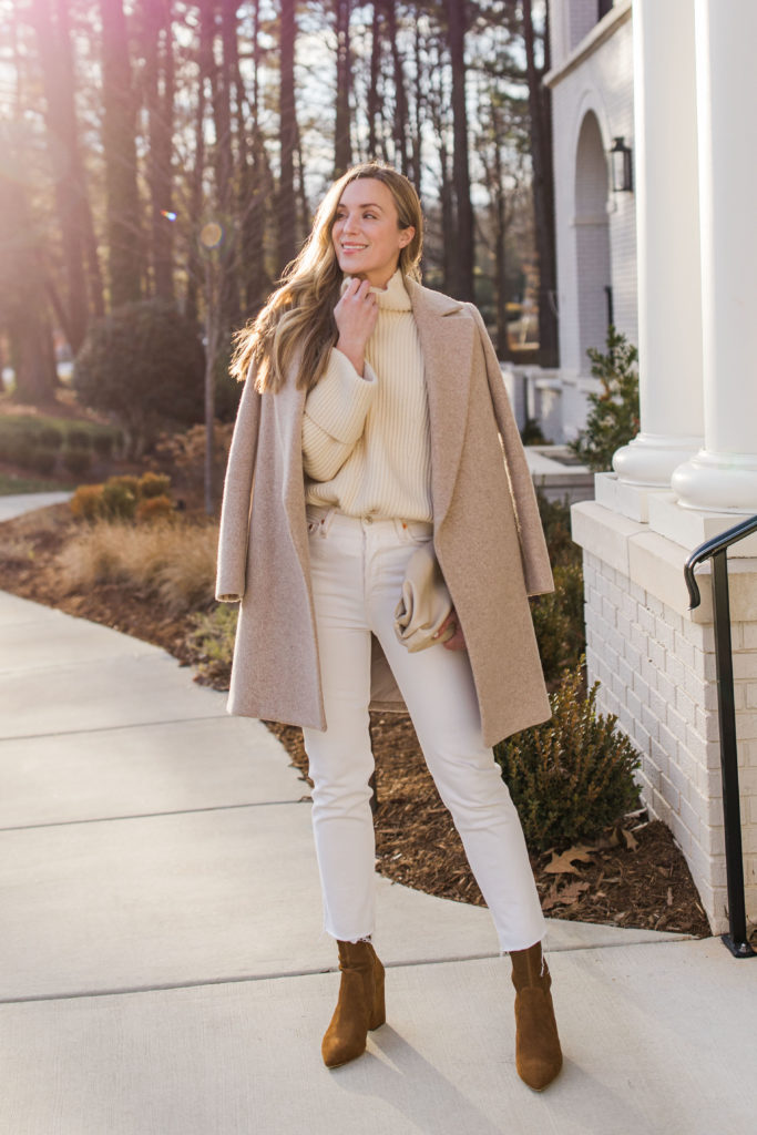 woman wearing neutral winter outfit with theory camel coat RE/DONE white jeans Loeffler Randall Isla boots and banana republic oversized sweater