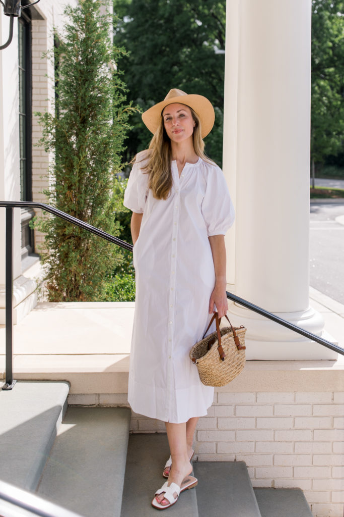 white staud vincent dress outfit with janessa leone hat mango bag and white sandals