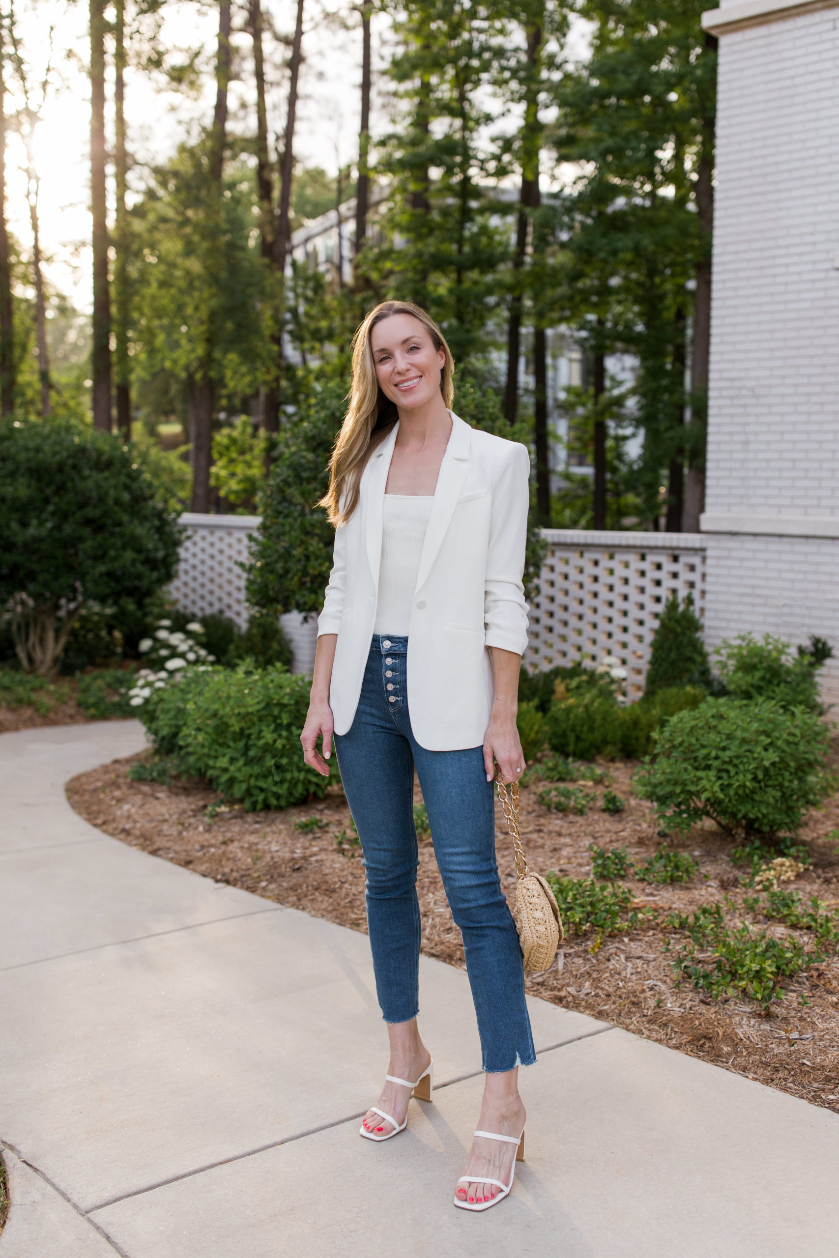 white blazer outfit with blue jeans and heeled sandals