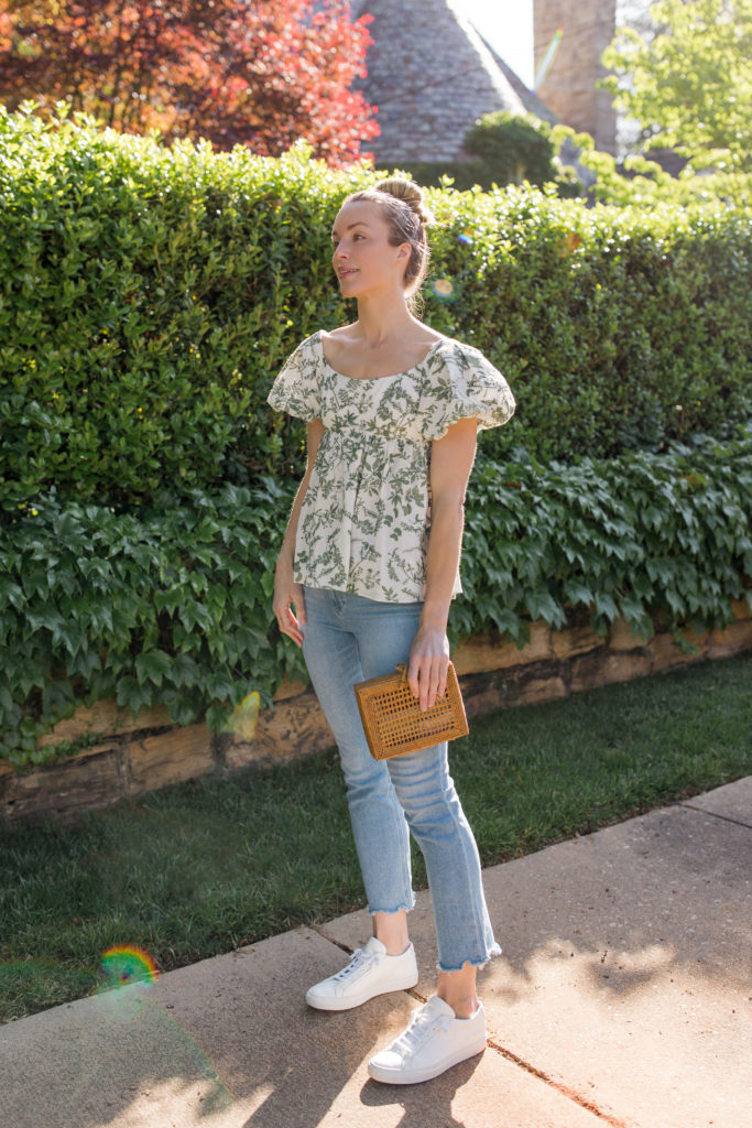 floral blouse with light blue jeans and white sneakers