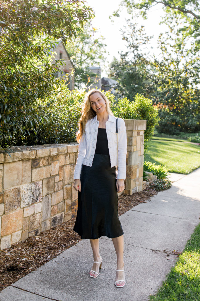 natalie yerger wearing AG Robyn white jean jacket vince black tank top max mara alessio satin skirt amazon the drop heeled sandals