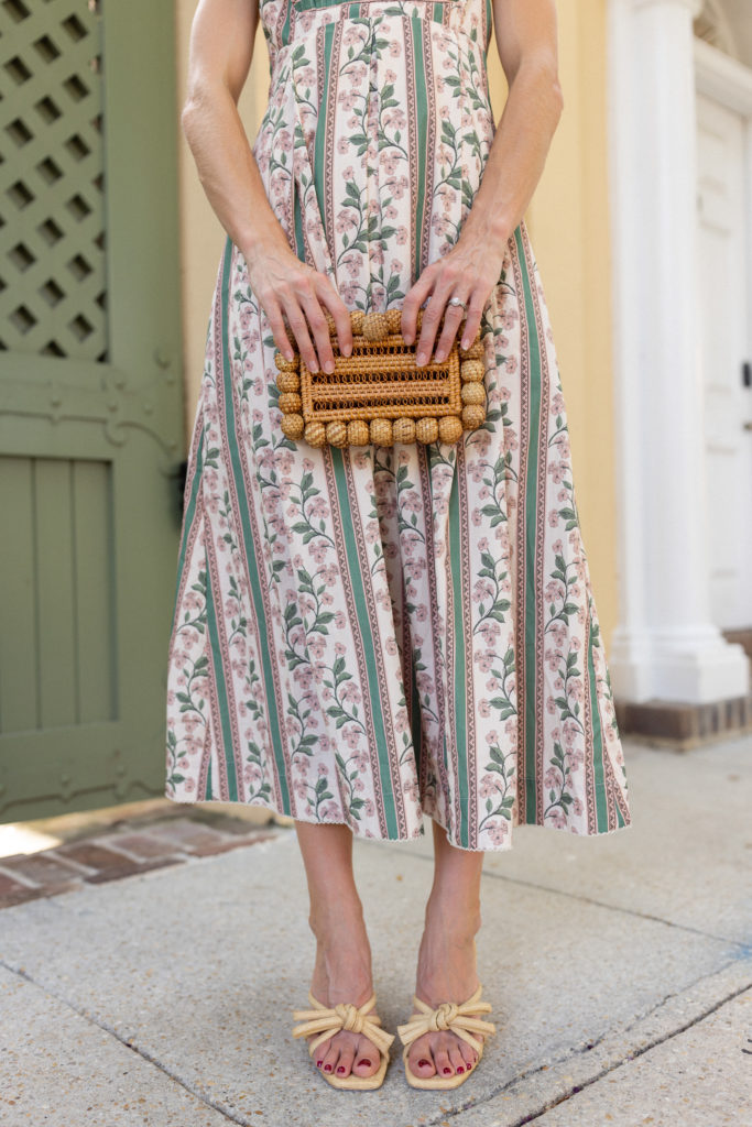 blogger wearing agua by agua bendita hortensia dress outfit with cula gaia eos clutch and loeffler randall margi natural bow heel