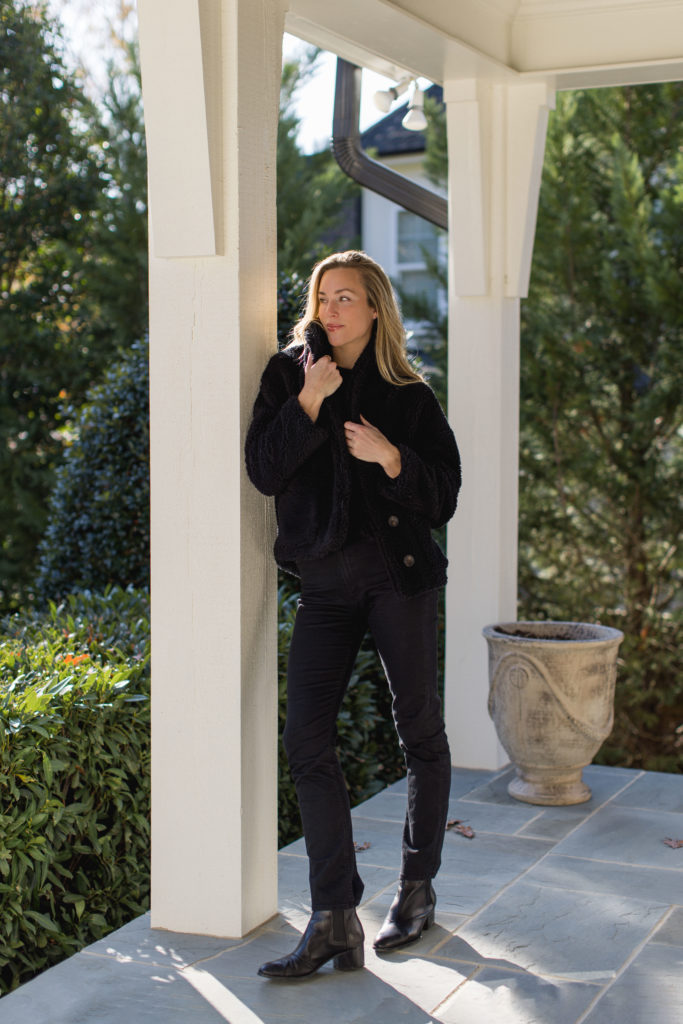 natalie yerger wearing velvet and graham black winter sherpa jacket black long sleeve sweater black mother jeans in a winter staple outfit