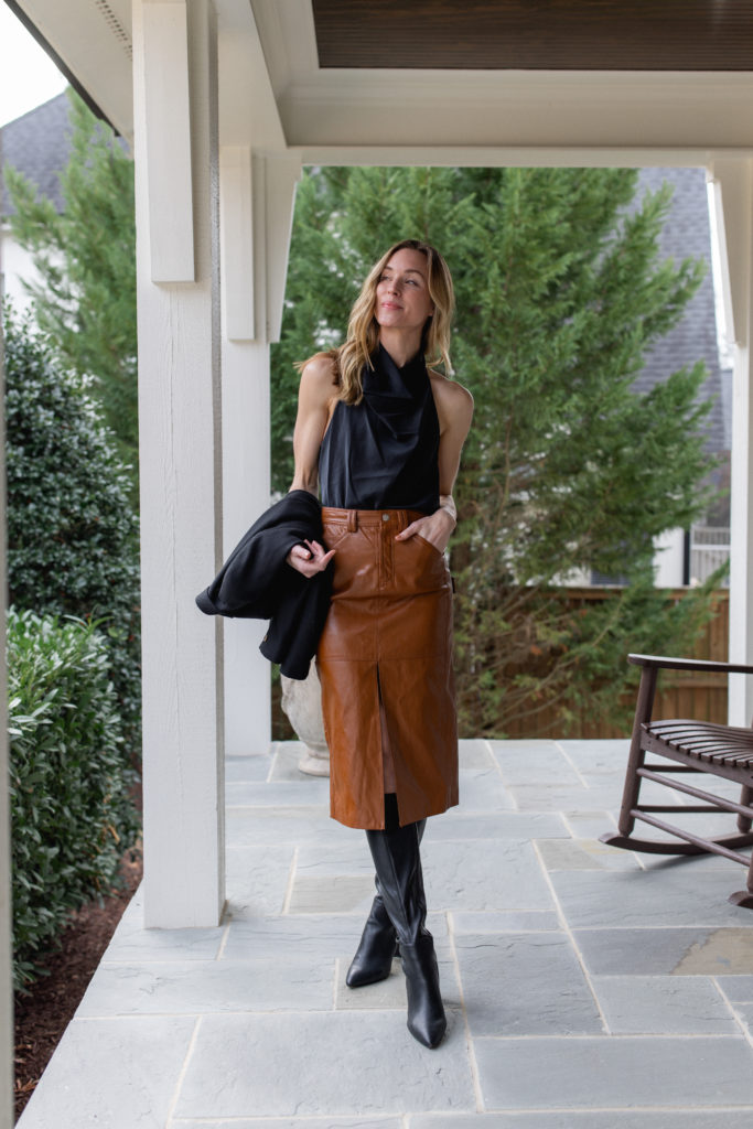 natalie yerger wearing ALC brown slit leather skirt with tall black boots and black halter top