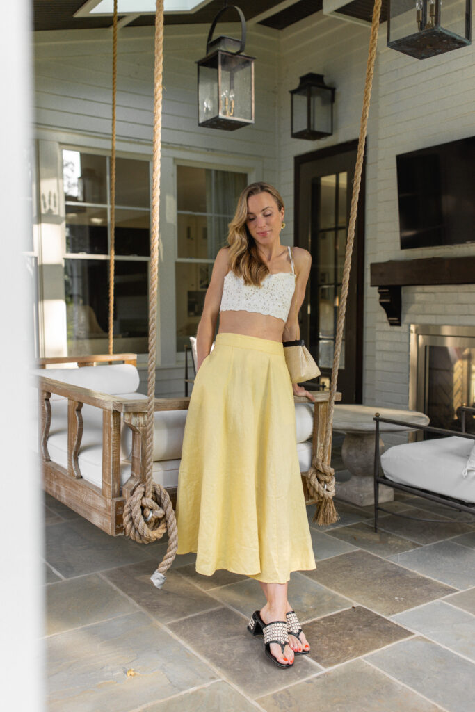 designer straw clutch outfit with yellow linen skirt and white crop top